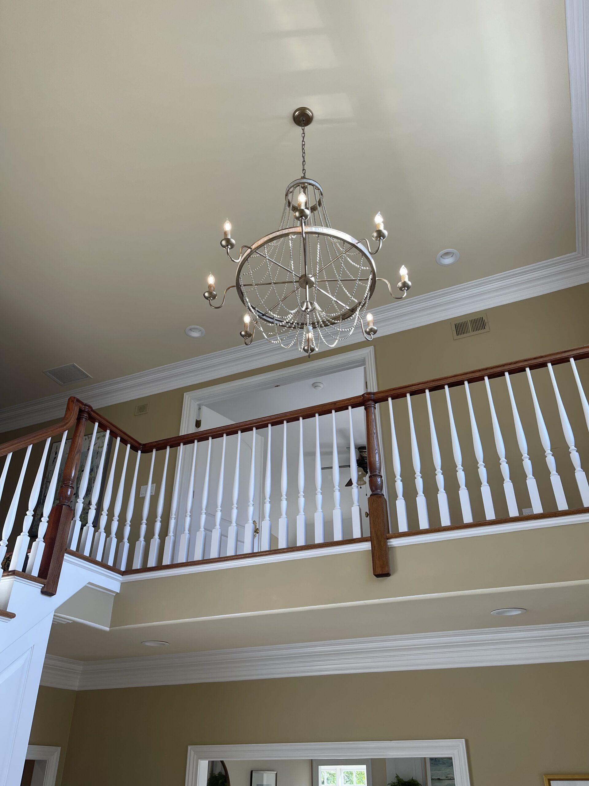 Grand chandelier lighting in a two-story foyer of a home in Morristown, NJ.
